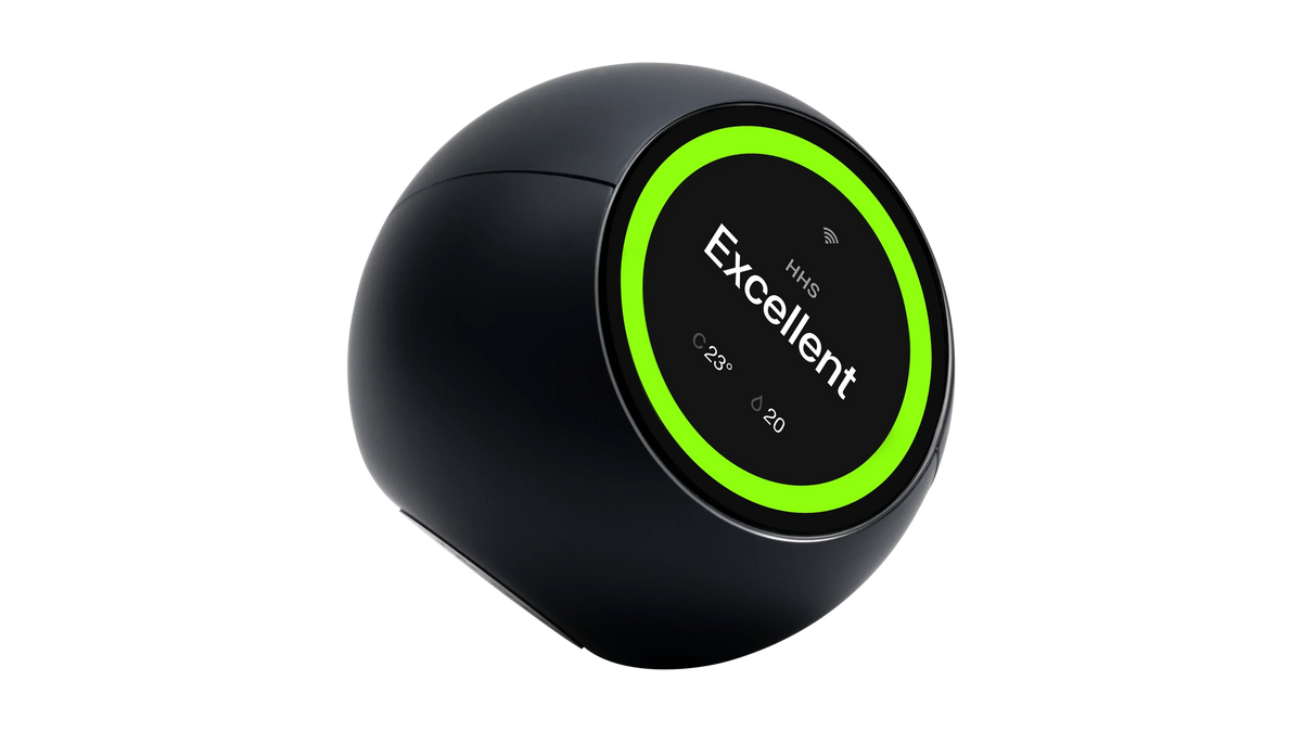 Matte black palm-sized air quality monitor on a plain background, a tilted spherical body whose circular screen is ringed in bright green and reads Excellent, with a temperature and humidity figure below.
