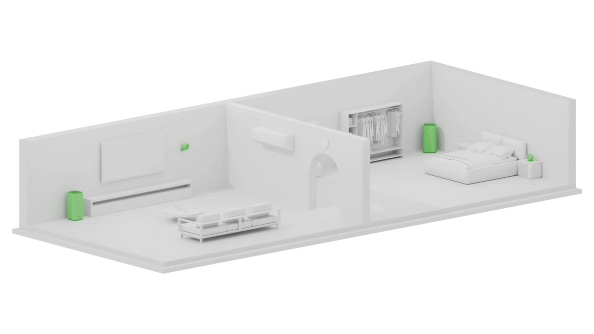 White three-dimensional cutaway model of a two-part apartment, a lounge with a sofa and wall-mounted TV at one end and a sleeping area with a wardrobe at the other, an air purifier highlighted in green standing in each space and a small green air monitor in both.